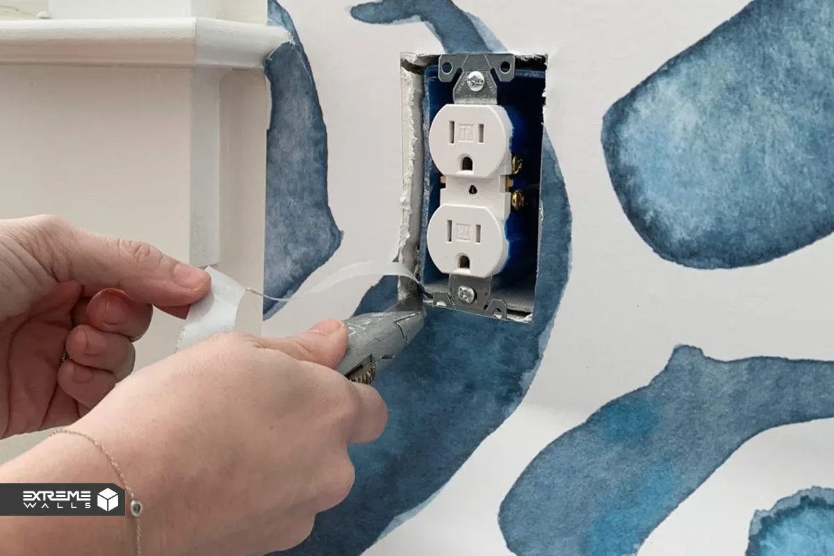 برش تمیز و دقیق کاغذ دیواری اطراف کلید برق با طرح داماسک کلاسیک